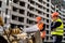 wonderful male workers in uniform and with helmets consider a construction plan on a grader