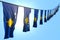 Wonderful many Kosovo flags or banners hanging diagonal on string on blue sky background with selective focus - any occasion flag