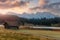 Wonderful misty morning with colorful sky over the mountain valley.  View over Geroldsee with wooden hut and Karwendel mountains