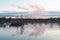 A wonderful  morning with colored clouds in the sky by a marsh lake.