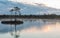 A wonderful  morning with colored clouds in the sky by a marsh lake.