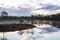 A wonderful  morning with colored clouds in the sky by a marsh lake.