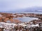 Wonderful mountain landscape with a cape on the shore of the Barents sea. Amazing sunrise landscape with polar white snowy range