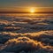 A wonderful photograph showing the sunrise above the clouds. The golden sunlight illuminates the pure white clouds.