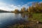 Wonderful picturesque Scene. Awesome Autumn landscape with colorful sky, reflected on the calm river. Amazing nature counryside. I