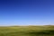 Wonderful prairie background - beautiful grass hills and a clear blue sky
