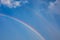 Wonderful rainbow with blue sky and white clouds