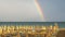 Wonderful rainbow over the Adriatic sea. Contrast between the bright colors of the rainbow and the green sea