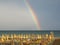 Wonderful rainbow over the Adriatic sea. Contrast between the bright colors of the rainbow and the green sea