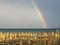 Wonderful rainbow over the Adriatic sea. Contrast between the bright colors of the rainbow and the green sea