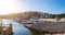 Wonderful romantic summer evening landscape marine in backlit sunset sunbeam panorama at coastline Adriatic sea. Fishing boats