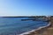 Wonderful scenery of Paphos city with mediterranean sea and total blue sky. Seashore with stone wharfs and white building in