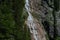 wonderful steep waterfall over rocks in the mountains