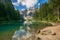Wonderful summer scenery on Braies Lake Lago di Braies and larch trees with reflection in the water. Fanes-Sennes-Prags Fanes-S