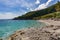 The wonderful turquoise color of the sea between the mountains and the rocky shore