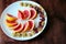 Wonderful vegan food: grapefruit sliced with slices, walnut kernels, dried cranberries stand on a white plate