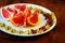 Wonderful vegan food: grapefruit sliced with slices, walnut kernels, dried cranberries stand on a white plate