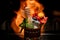 wonderful view of glass with mint and berries and honey dipper on background of fire