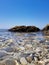 Wonderful view of the surface of the water. Through the clear water with blue and green shades you can see the seabed with rocks,