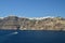 Wonderful Views Of The City Of Fira On Top Of A Mountain On The Island Of Santorini From High Seas With A Boat Transporting Passen