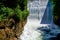 wonderful white rushing waterfall over a dam wall