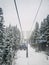 Wonderful winter scene with snow falling while climbing to the top of the mountain on a cable car gondola. Bukovel ski resort in