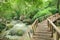 Wonderful wooden bridge across a waterfall, Thailand