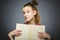 Wondering girl with book. Closeup teen on grey background. studies concept