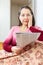 Wonderingly woman having grief after readed newspaper