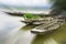 The wonderland of wooden boat float in reservoir with halo