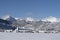 wondrous freshly snow-covered tourism village of heiterwang with wispy clouds on the hahnenkamm mountain range