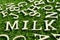 Wood alphabet as wording milk on artificial green grass