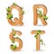 Wood alphabet with branch green leaves