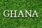 Wood alphabet in word Ghana on green grass background