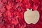 Wood apple shaped flat decoration on a background of red maple leaves, fall background