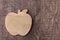 Wood apple shaped flat decoration on a dark wood background, fall background