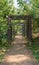 Wood arch above pathway in the park