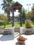 wood belfry in little green garden with two metal bells