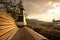 Wood bench with background of windmill and mountain at sunset li