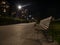 Wood bench in an illuminated walkway of Milan