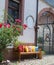 Wood bench outside with much multicolor pillows