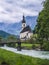 A wood bench with parish church, river abd mountains in background. berchtesgaden, Ramsau Germany