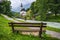 A wood bench with parish church, river abd mountains in background. berchtesgaden, Ramsau Germany