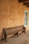 Wood bench beside teal trimmed window