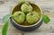 Wood-bowl with new harvest custard apple on wooden background