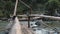 Wood bridge over bubbling mountain river thailand