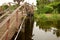 Wood bridge over a small canal behind the trees