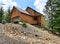 Wood cabin style home on the rocky hill with garage.
