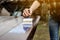 Wood carpenter applies a protective layer of transparent varnish. Hand with a brush close up on the table top