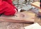 Wood carver craftsman carves a snowflake on a board